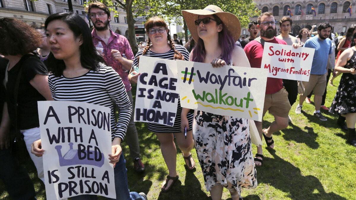 Employees of Wayfair march in Boston to protest the company's decision to sell furniture to a government contractor that runs a detention center for migrant children.