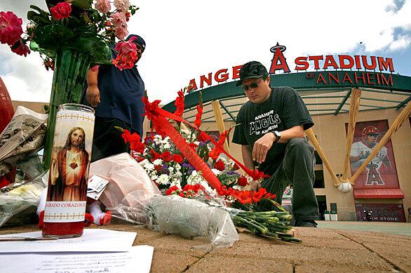 Robert Vargas and Jason Lozano are among the many Angel fans stopping by Angel Stadium in Anaheim to pay tribute to pitcher Nick Adenhart, who was among three people killed in a car accident earlier in the day.