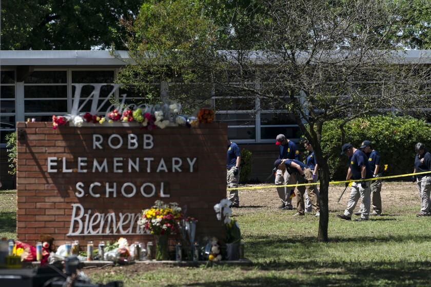 FILE - Investigators search for evidences outside Robb Elementary School in Uvalde, Texas, May 25, 2022, after an 18-year-old gunman killed 19 students and two teachers. The district’s superintendent said Wednesday, June 22, that Chief Pete Arredondo, the Uvalde school district’s police chief, has been put on leave following allegations that he erred in his response to the mass shooting. (AP Photo/Jae C. Hong, File)