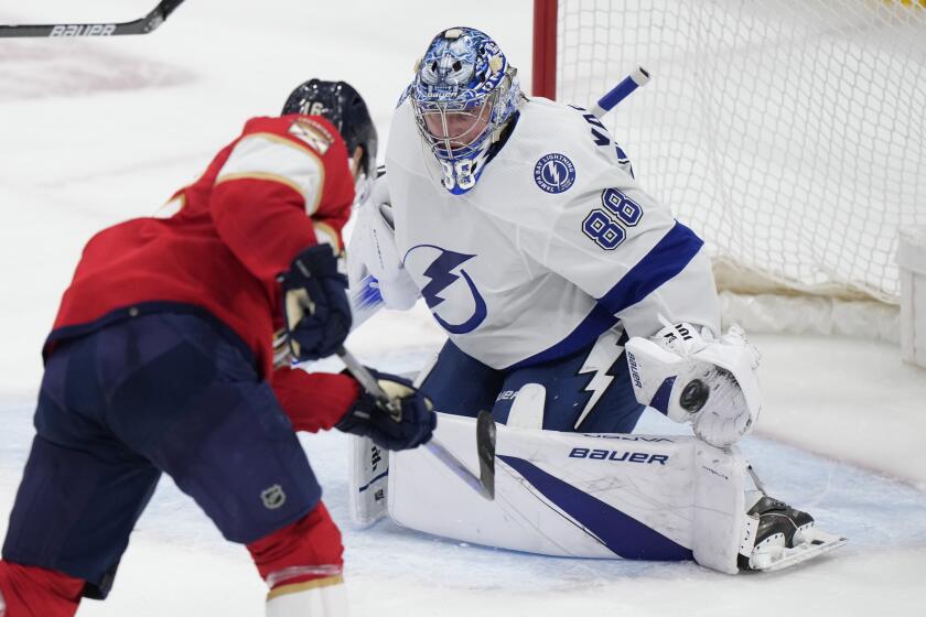 Tampa Bay Lightning goaltender Andrei Vasilevskiy (88) makes a save against Florida Panthers center Aleksander Barkov during the second period of Game 2 of the first-round of an NHL Stanley Cup Playoff series, Tuesday, April 23, 2024, in Sunrise, Fla. (AP Photo/Wilfredo Lee)