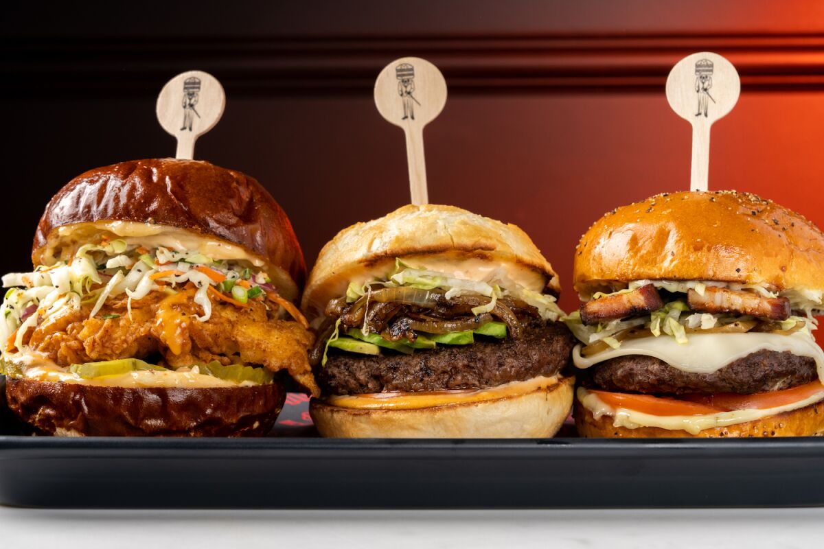 Three different burgers lined up next to one another