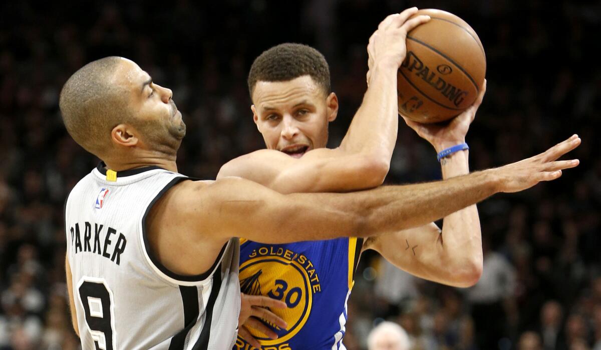 Spurs point guard Tony Parker plays tight defense against Warriors point guard Stephen Curry during their game Saturday night in San Antonio.