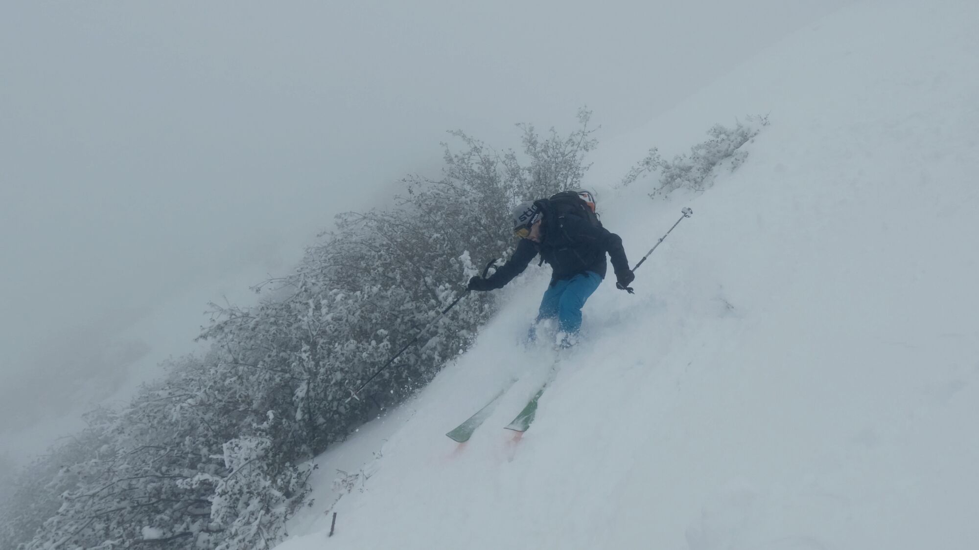 Matthew Testa skis down the west face of Mt. Lukens in white-out conditions on Sunday.