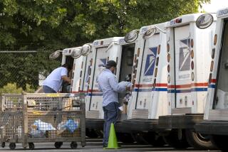 FILE - In this Aug. 20, 2020 file photo, postal workers load their mail delivery vehicles at the Panorama city post office in Los Angeles. The Nov. 3 election will test California's commitment to voting by mail as the nation's most populous state will offer fewer in-person polling places hoping it will convince more people to cast ballots from the safety of their mailboxes during a pandemic. If it doesn't work, the state could see long lines and frustrated voters on Election Day compounded by coronavirus protocols that will make voting in person slower in a year expected to draw a big turnout. (AP Photo/Richard Vogel, File)