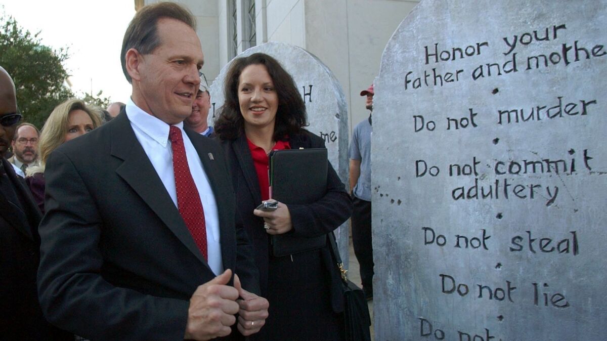 Alabama GOP senate candidate Roy Moore looking at a Ten Commandments display in Montgomery, Ala. in 2003.