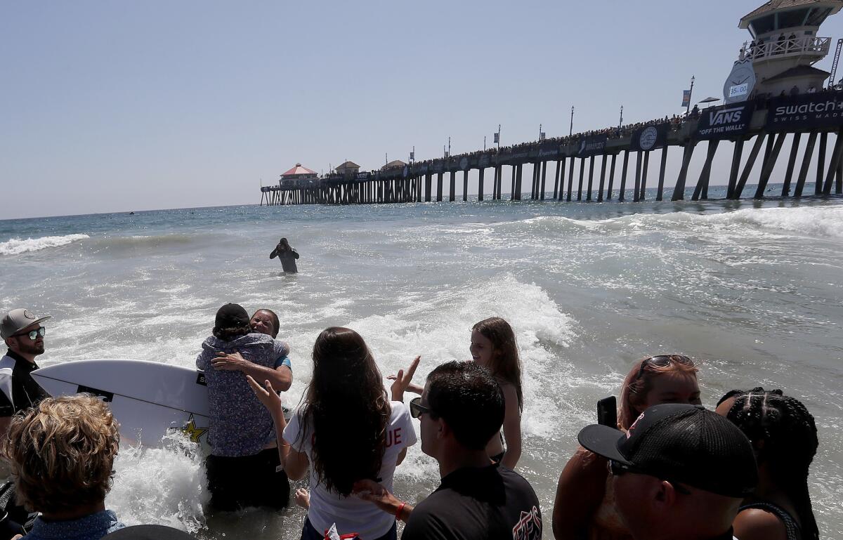HUNTINGTON BEACH, CALIF. - AUG. 5, 2018. Courtney Conlogue celebrates after defeating Stephanie Gilmore in the Women's Final of the 2018 Vans U.S, Open of Surfing on Sunday, Aug. 5, 2018, in Huntington Beach. (Luis Sinco/Los Angeles Times)