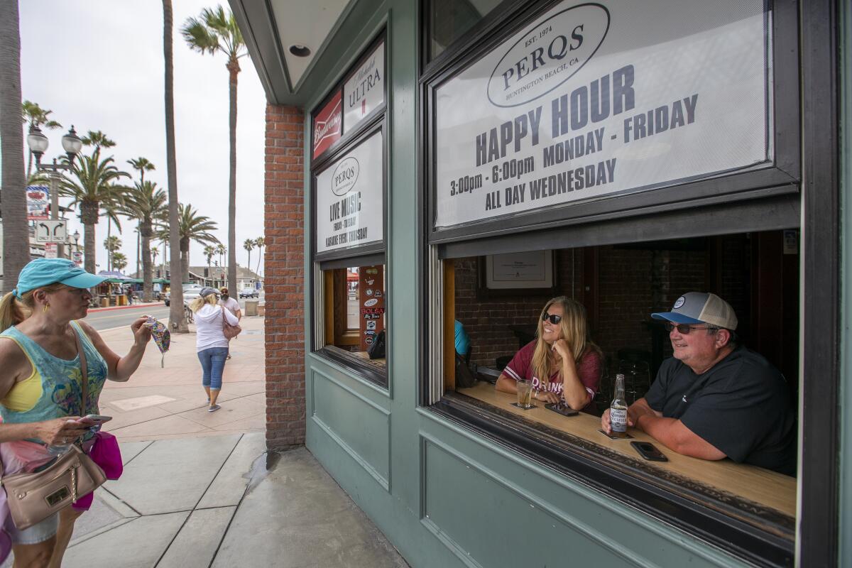 Visitors to Main Street in Huntington Beach chat