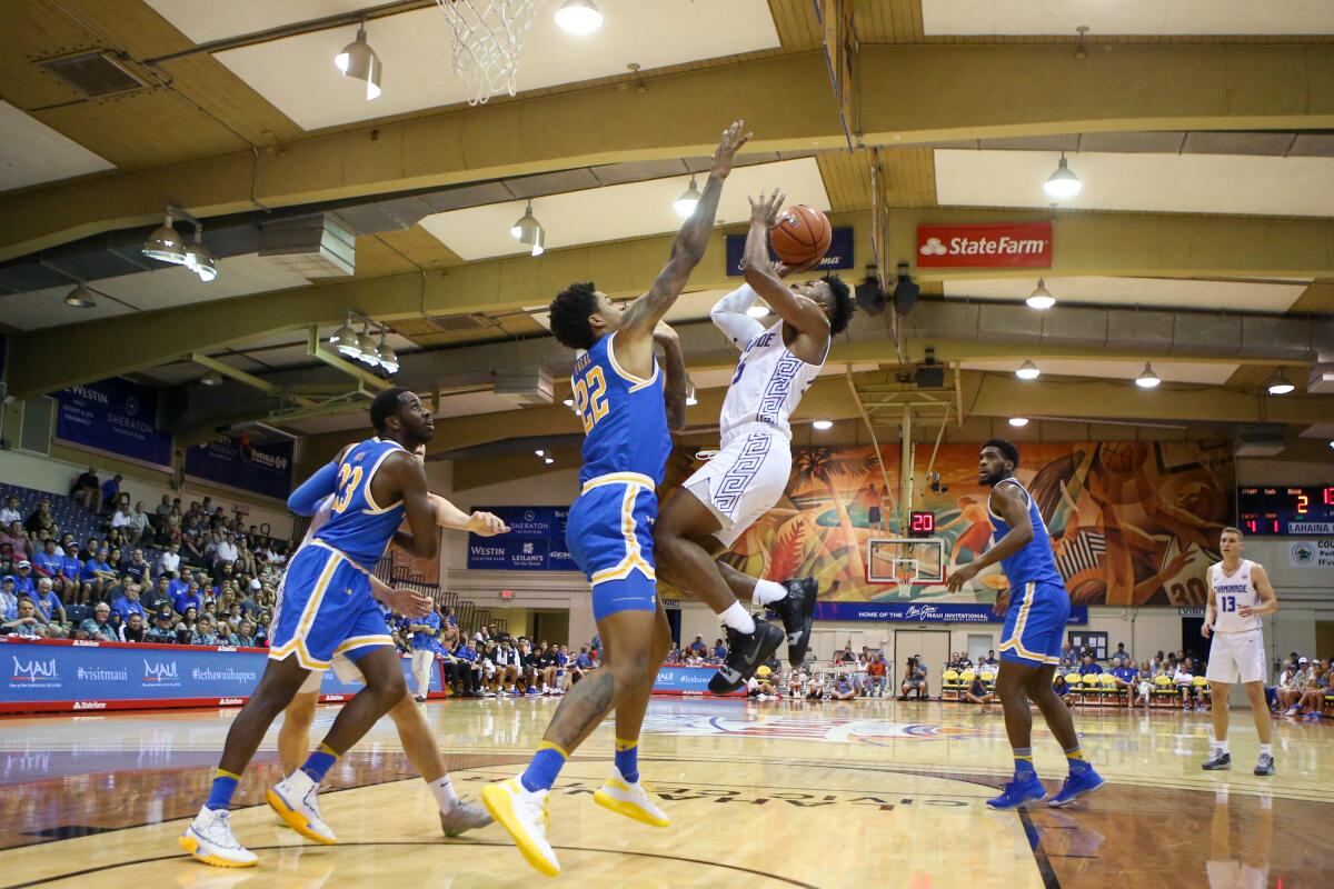 UCLA forward Shareef O'Neal stays in front of Chaminade guard Kendall Small as he shoots during a game Nov. 26 at the Maui Invitational.