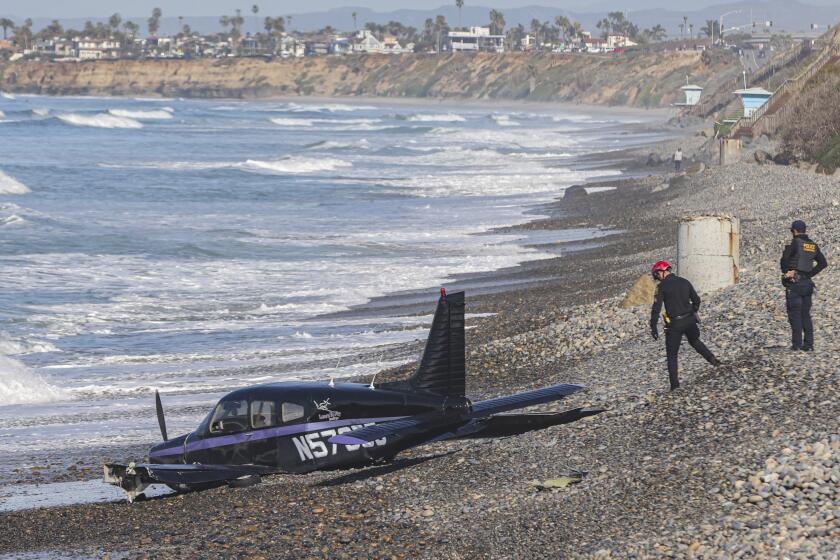 Carlsbad, CA - January 19: Officials investigate a small plane crash along the shoreline at South Carlsbad State Beach on Thursday, Jan. 19, 2023 in Carlsbad, CA. (Eduardo Contreras / The San Diego Union-Tribune)