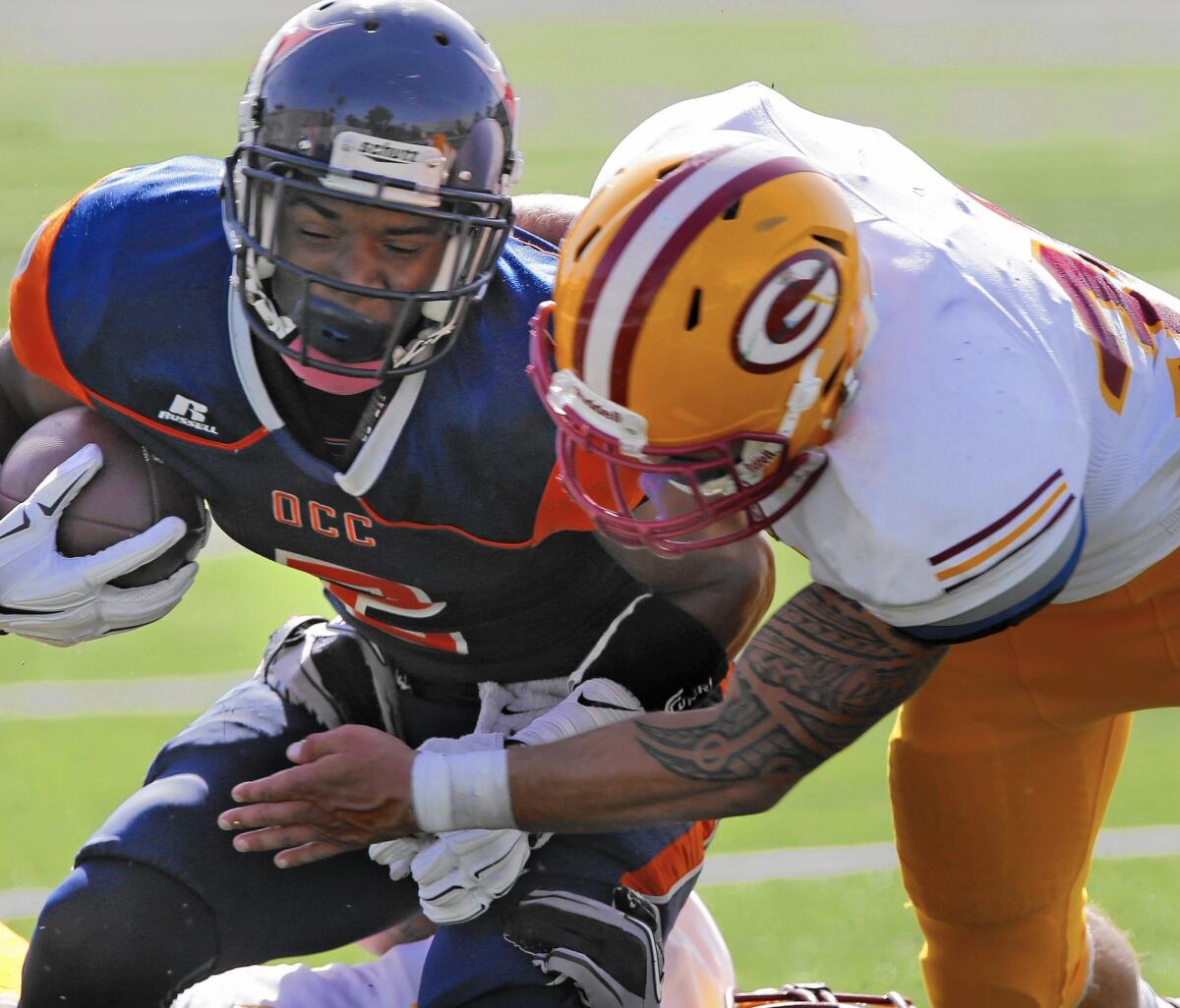 A player from Saddleback College makes a tackle.