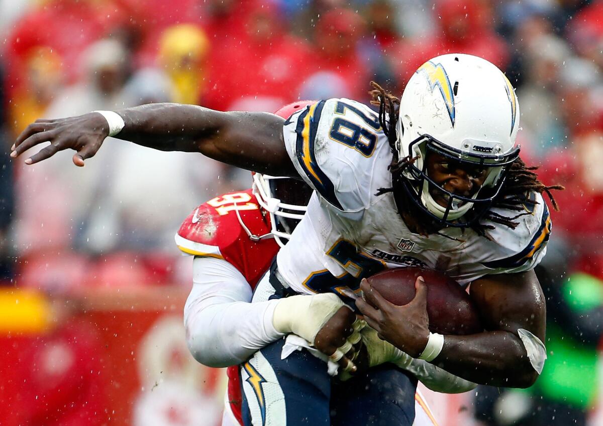 Chargers running back Melvin Gordon is tackled by Chiefs linebacker Tamba Hali during a game on Dec. 13.