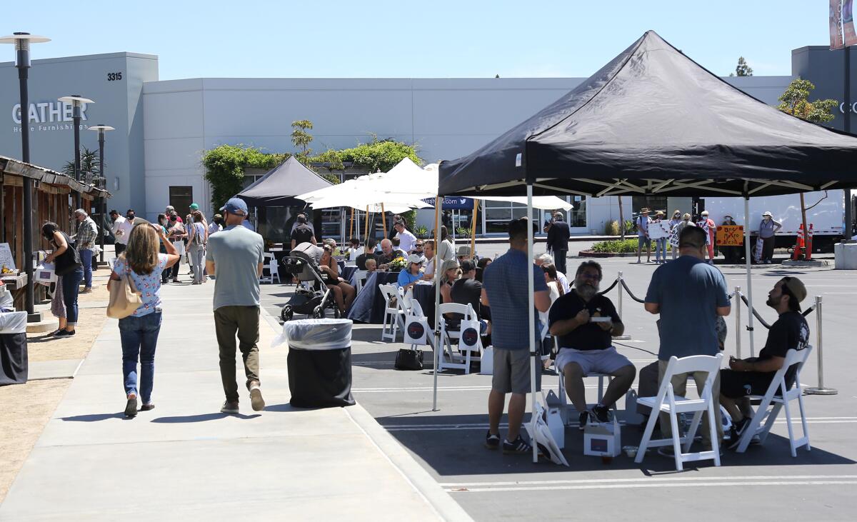 Guests mingle and have lunch at the neighborhood block party hosted by Rose Equities at the OC Mix on Friday, April 30, 2021.