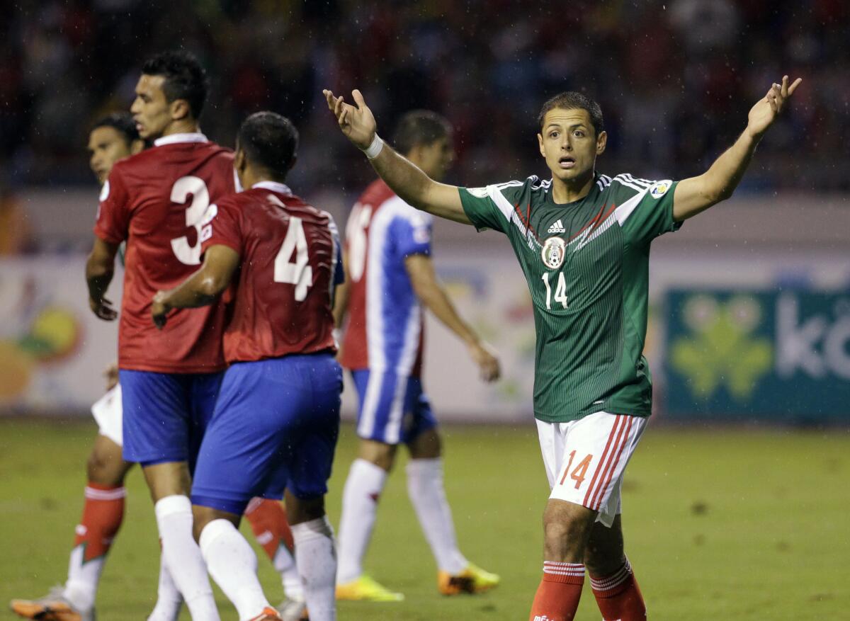 Mexico's Javier Hernandez, right, reacts after the referee disallowed a goal during a 2014 World Cup qualifying soccer match in San Jose, Costa Rica.