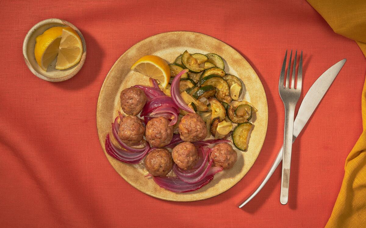 Meatballs on a plate with red onion and zucchini
