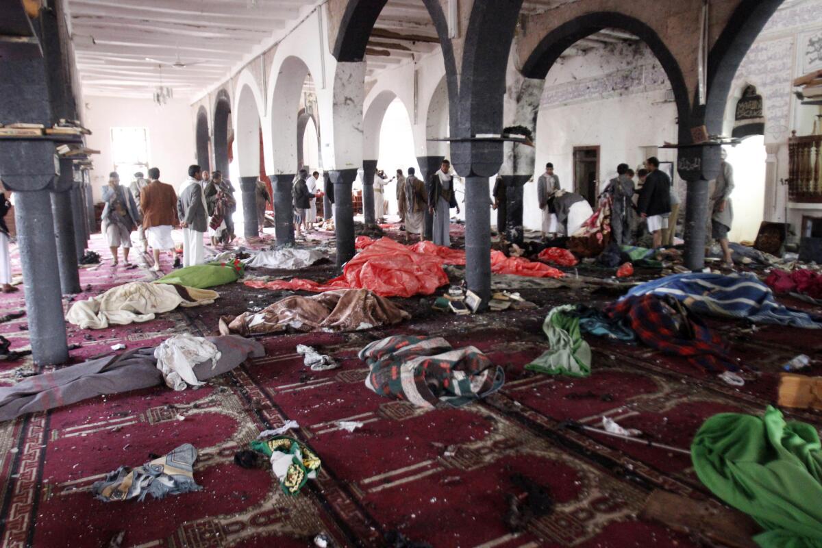 Bodies of people killed in a suicide attack during the noon prayer are covered in blankets in a mosque in Sana, Yemen, on Friday.