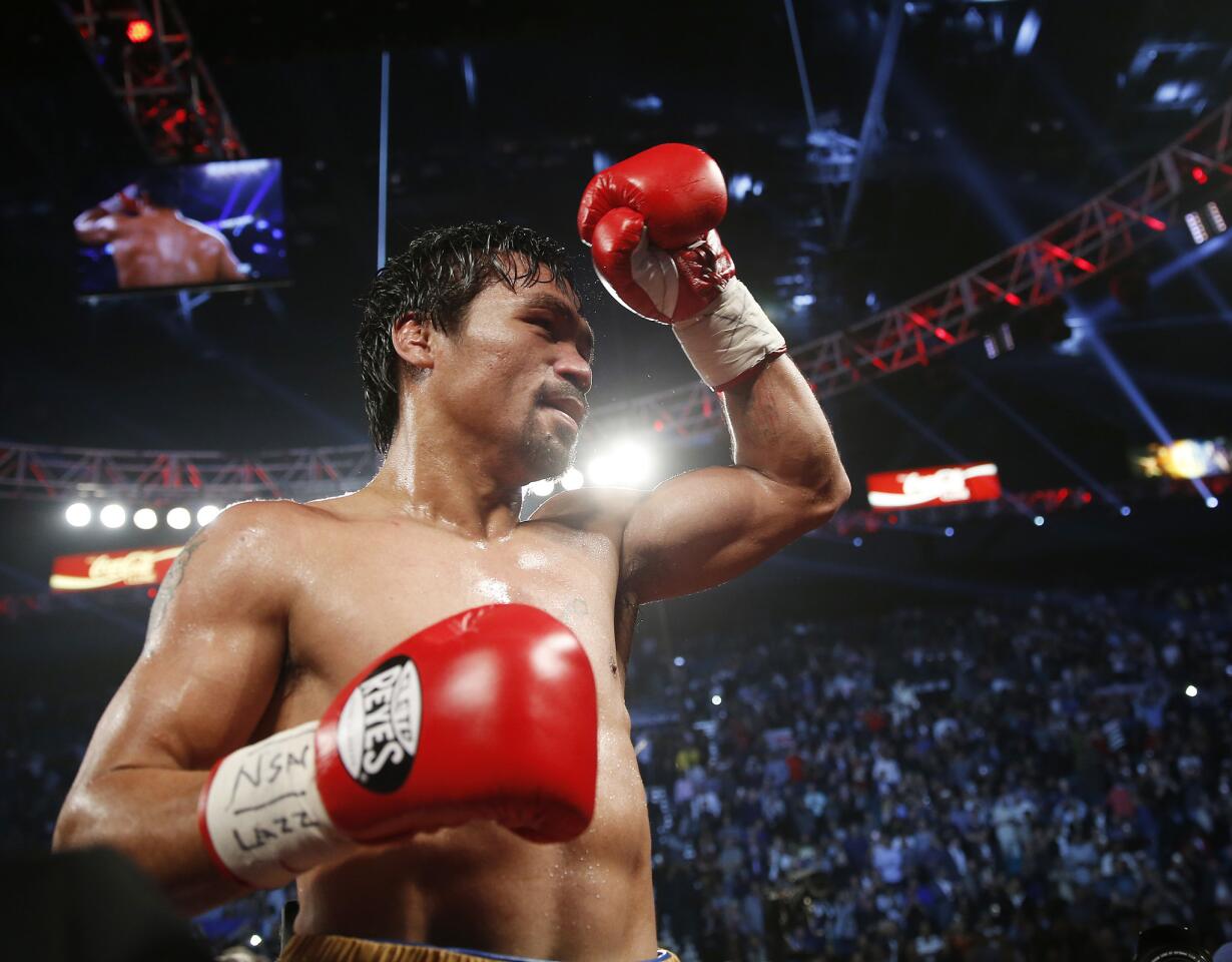 Manny Pacquiao, of the Philippines, celebrates after defeating Timothy Bradley in the WBO welterweight title boxing bout Saturday, April 9, 2016, in Las Vegas. (AP Photo/Isaac Brekken)