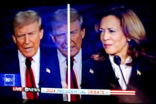 Donald Trump and Kamala Harris are shown on screen in the spin room during the second presidential debate