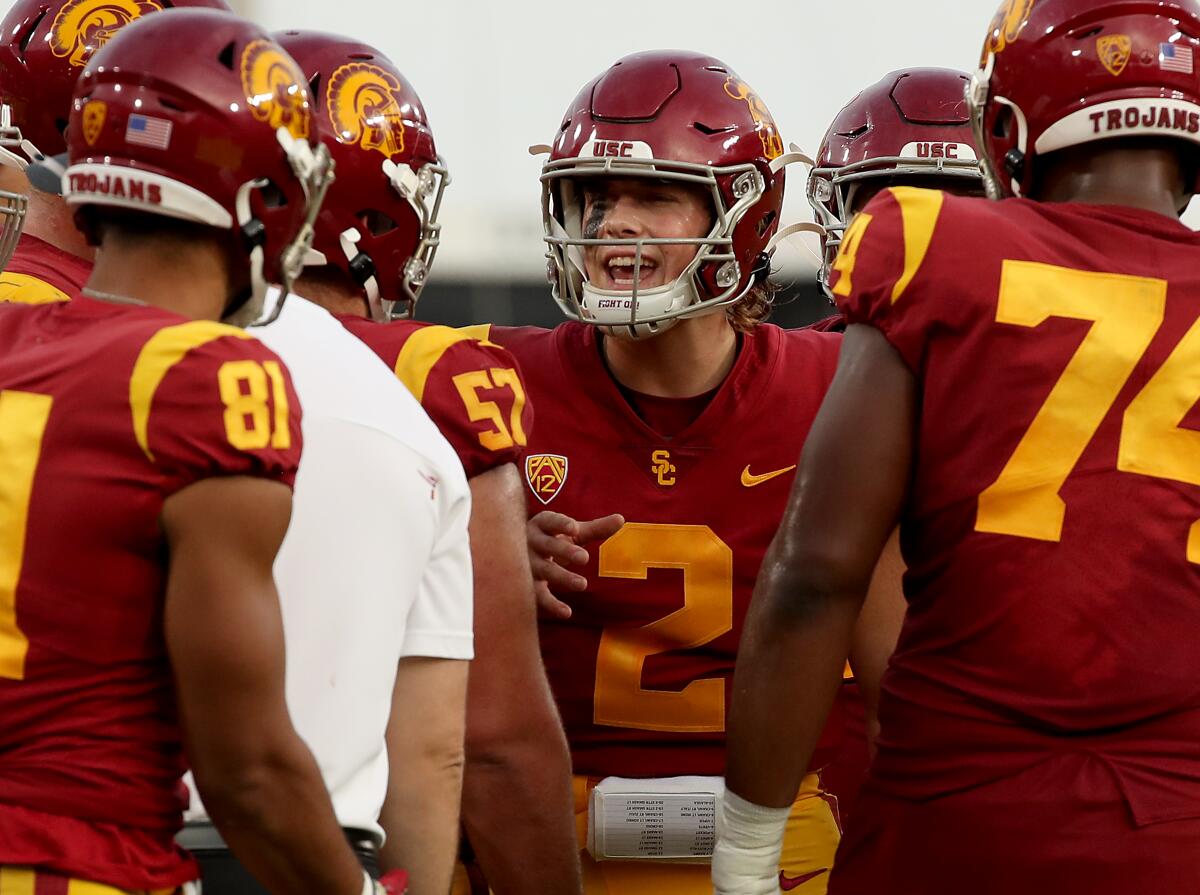 USC quarterback Jaxson Dart talks with teammates in a huddle