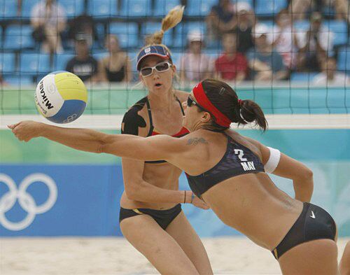 Misty May-Treanor uses her quick reactions to save a spike against Norway in preliminary round action in Beijing. May-Treanor and teammate Kerri Walsh did not lose a game in preliminary play.
