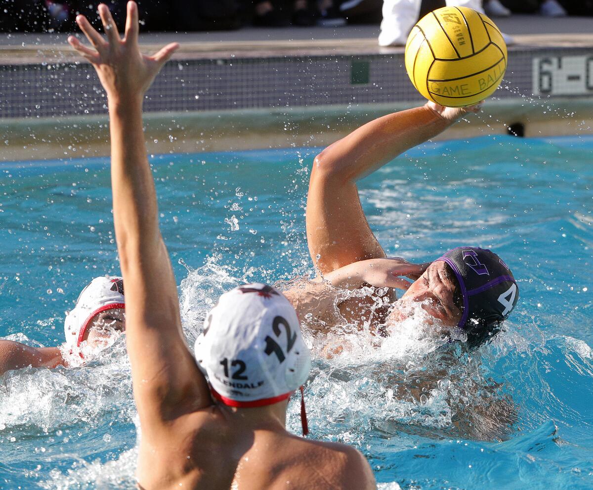 Hoover's Hayk Nazaryan, under a lot of pressure from the Glendale defense, shoots in a Pacific League boys' water polo match at Hoover High School on Wednesday, October 23, 2019. Hoover defeated Glendale 12-11 after coming from behind in the fourth quarter to win the match.