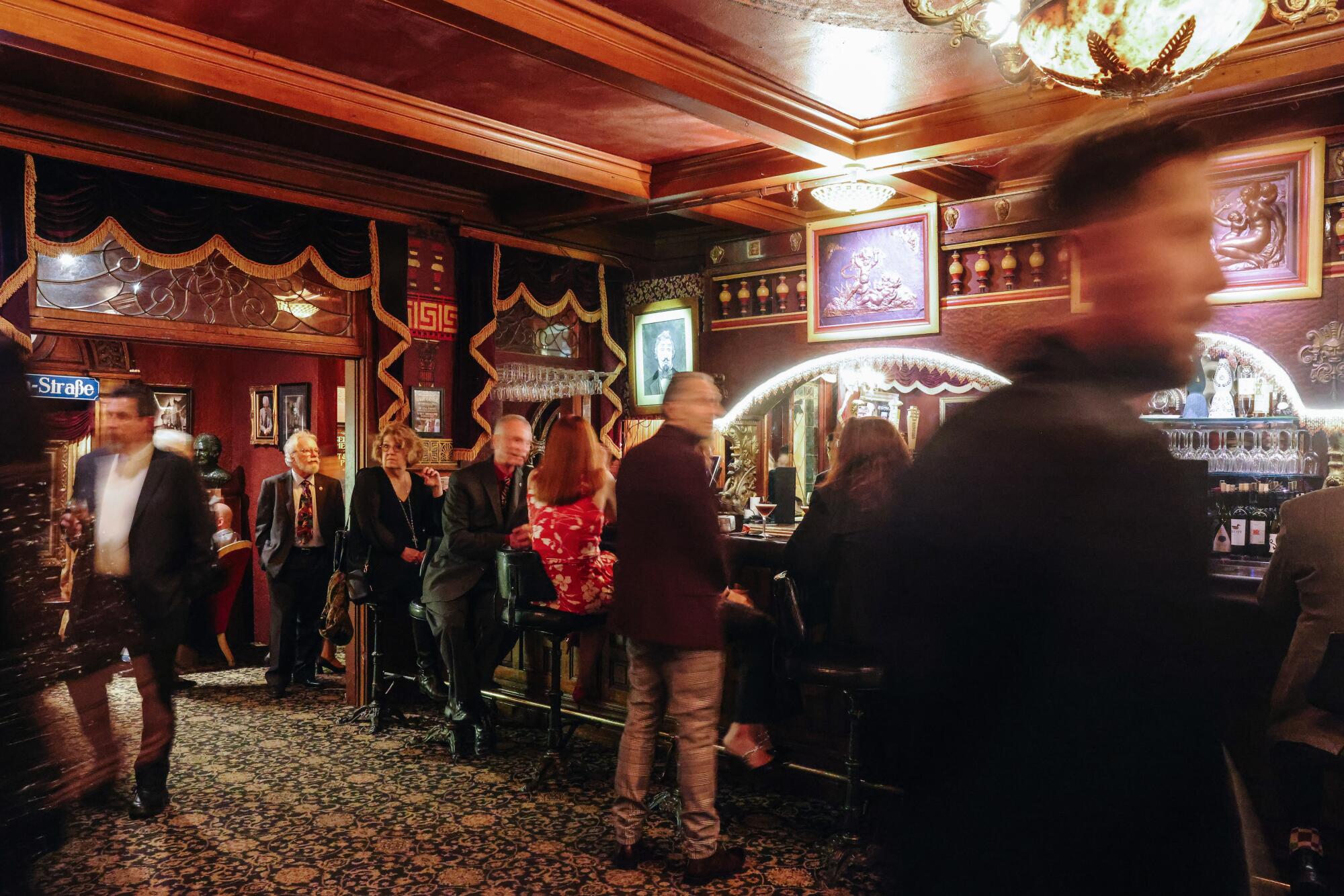 People order drinks at a bar inside the Magic Castle.