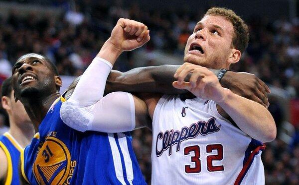 Clippers forward Blake Griffin and Warriors' Festus Ezeli battle for position.