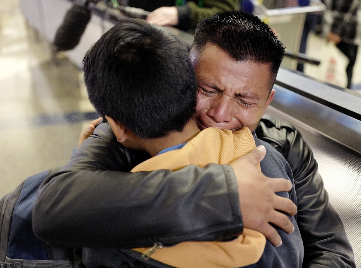 David Xol-Cholom, of Guatemala, hugs his son Byron at LAX 