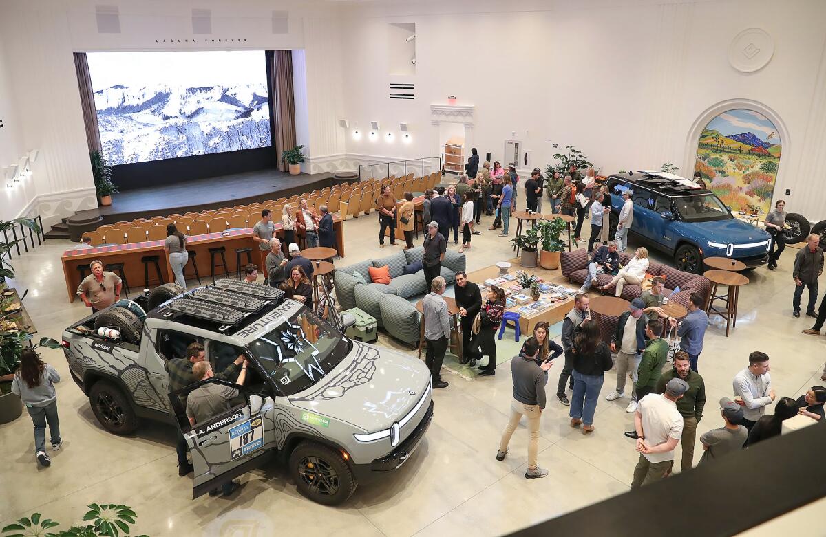 Guests enjoy a look of a new showroom and theater at the Rivian South Coast Theater during a dedication event on Friday.