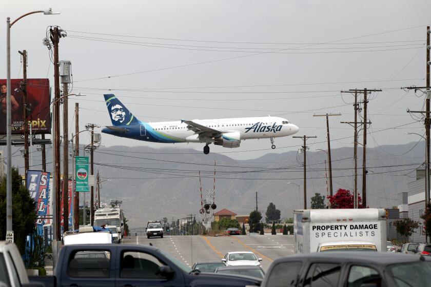An Alaska Airlines plane crosses Vineland Ave., in North Hollywood, at it lands at the Hollywood Burbank Airport, on Thursday, July 25, 2019.