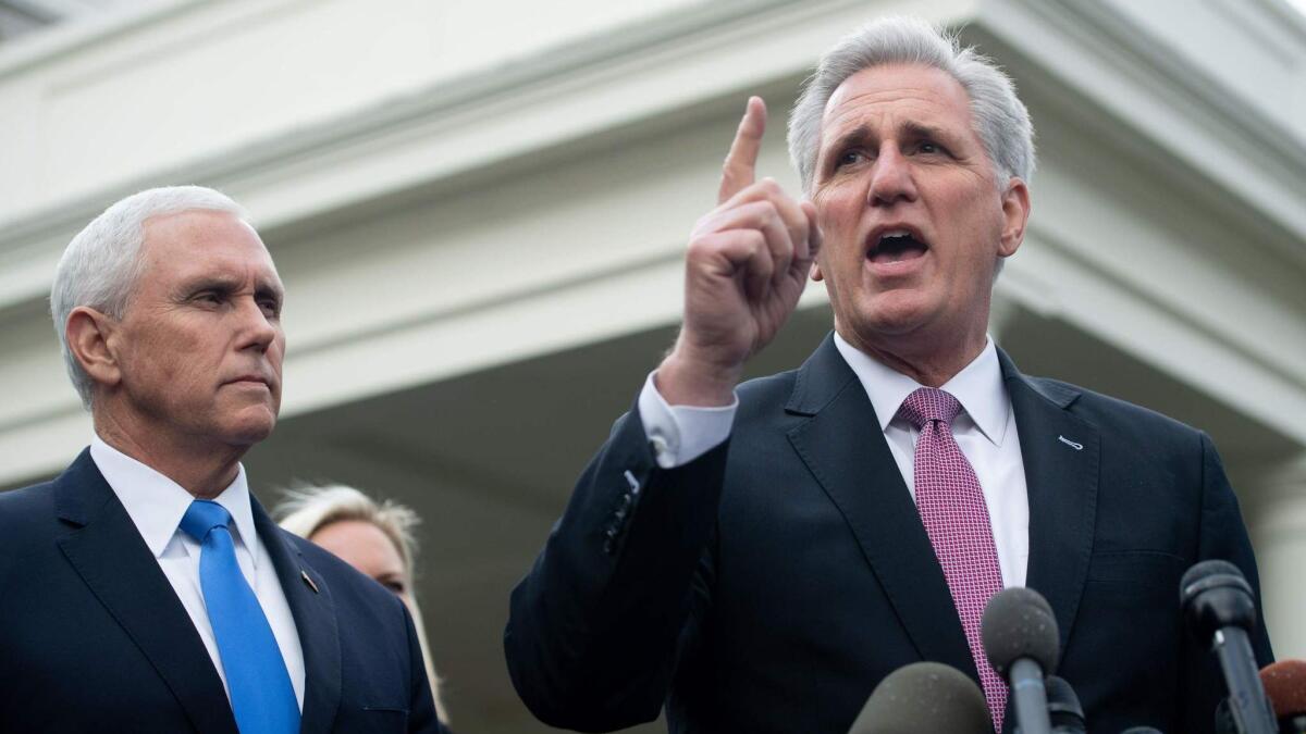 House Republican Leader Kevin McCarthy, right, speaks to the media on Jan. 9.