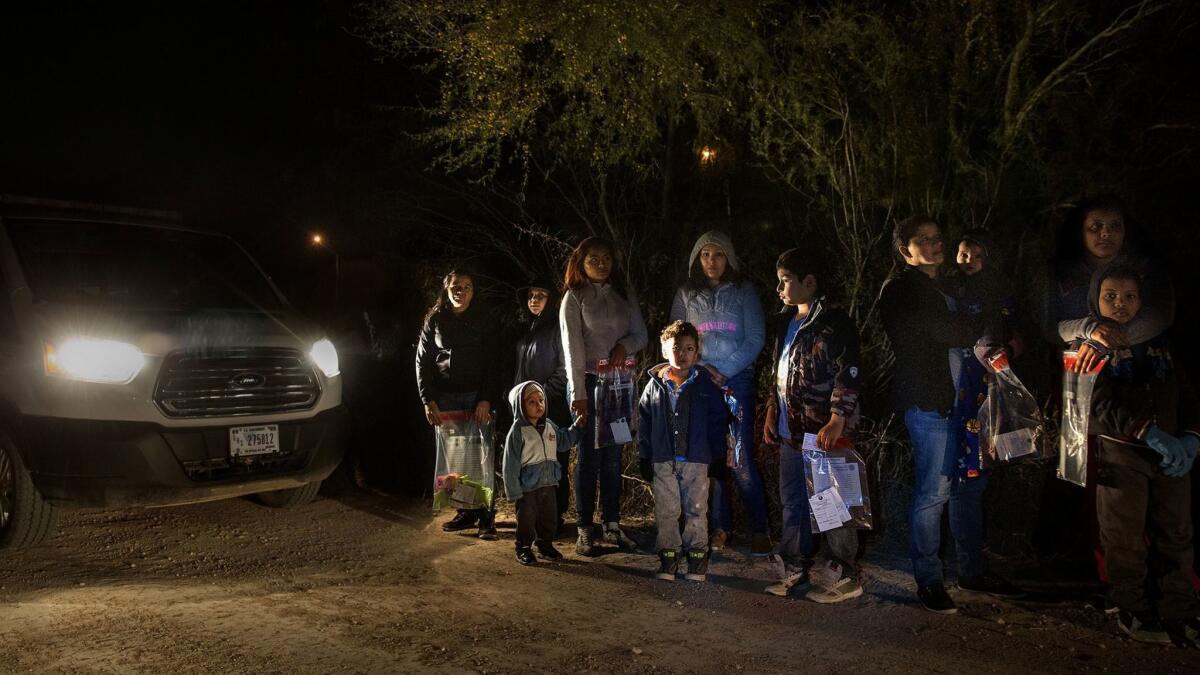 After crossing the Rio Grande River at night with the help of smugglers, group of mainly women and children from Central America are detained by U.S. Border Patrol agents before being taken into detention.