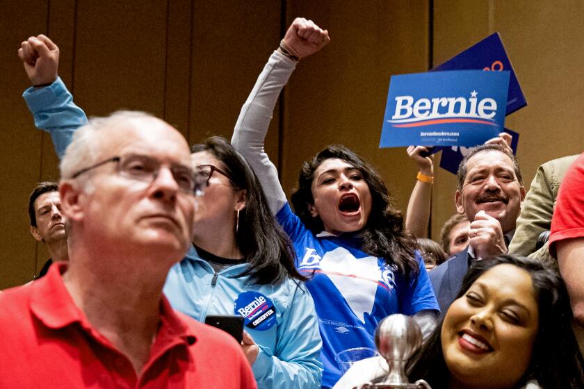 Supporters of Bernie Sanders react during the caucus in a ballroom of the Bellagio Hotel and Casino in Las Vegas, Nev. on Saturday.