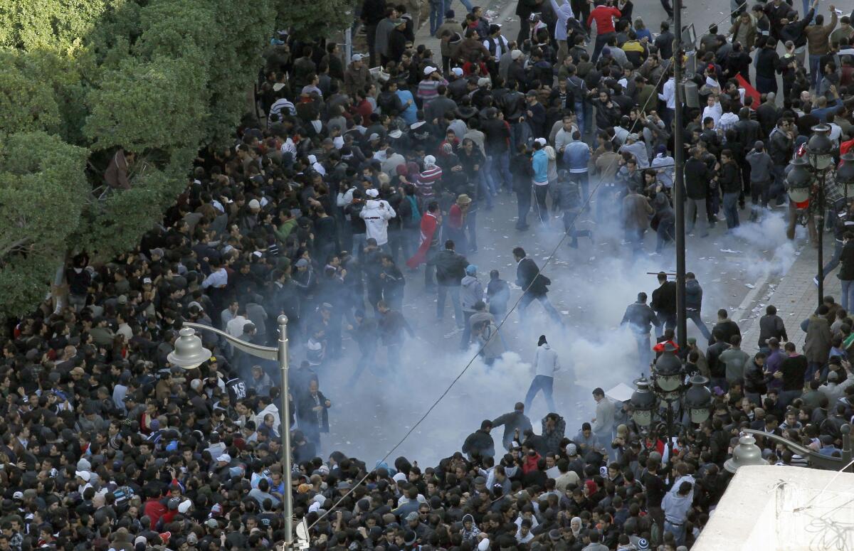 Police scatter demonstrators with teargas on Jan. 14, 2011, the day Tunisia long-time autocrat fled the country.