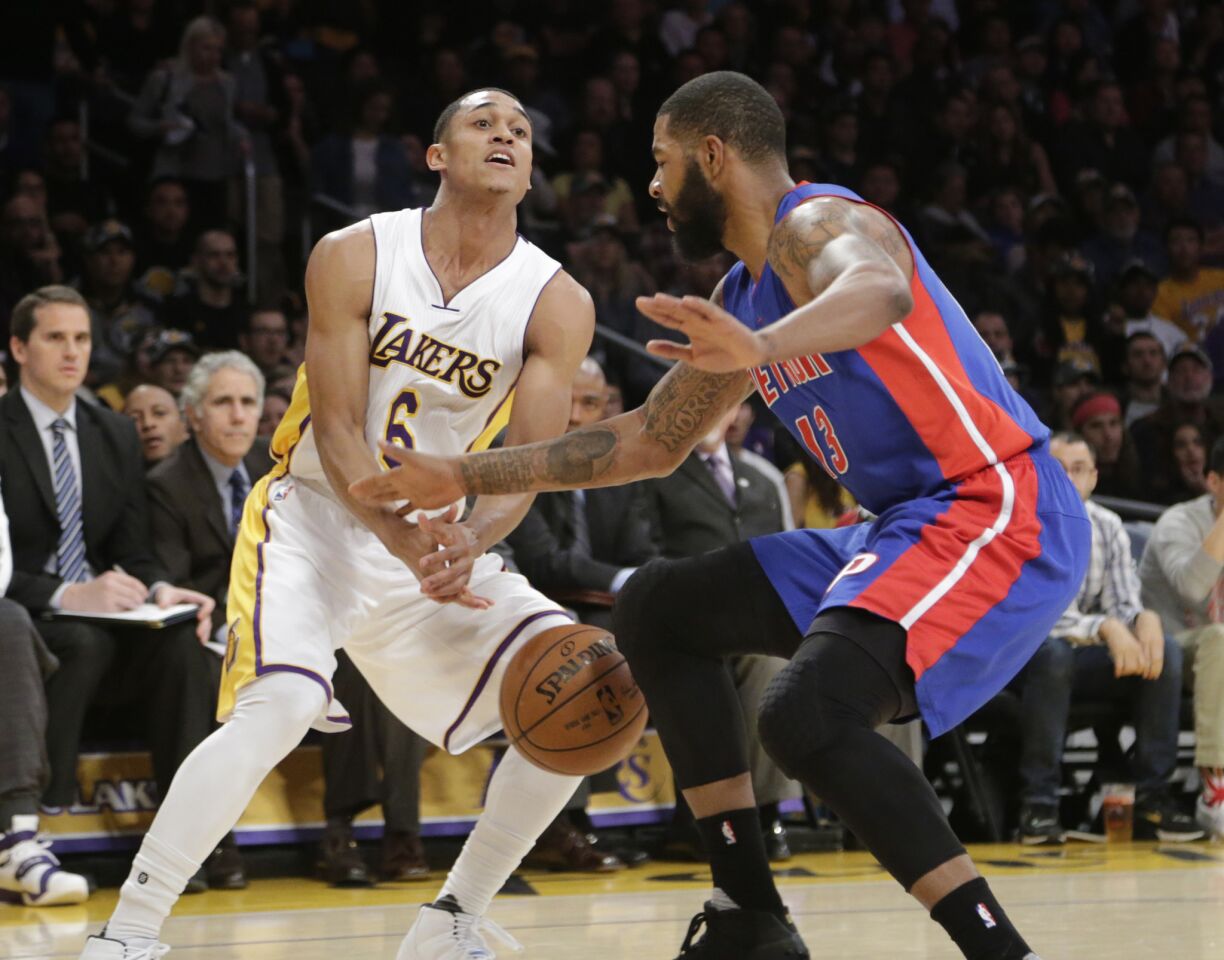 Lakers guard Jordan Clarkson gets the ball knocked loose by Pistons forward Marcus Morris in the first half.