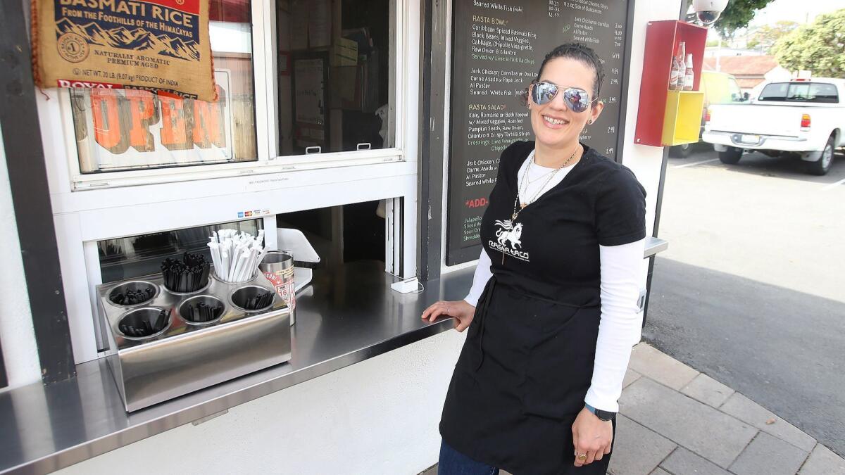 General manager and operator Alexa Welsh stands at Rasta Taco’s walk-up window at the corner of Beach Street and Ocean Avenue in Laguna Beach. She came to the shop last year after running the fine-dining establishment 42 Grams in Chicago.