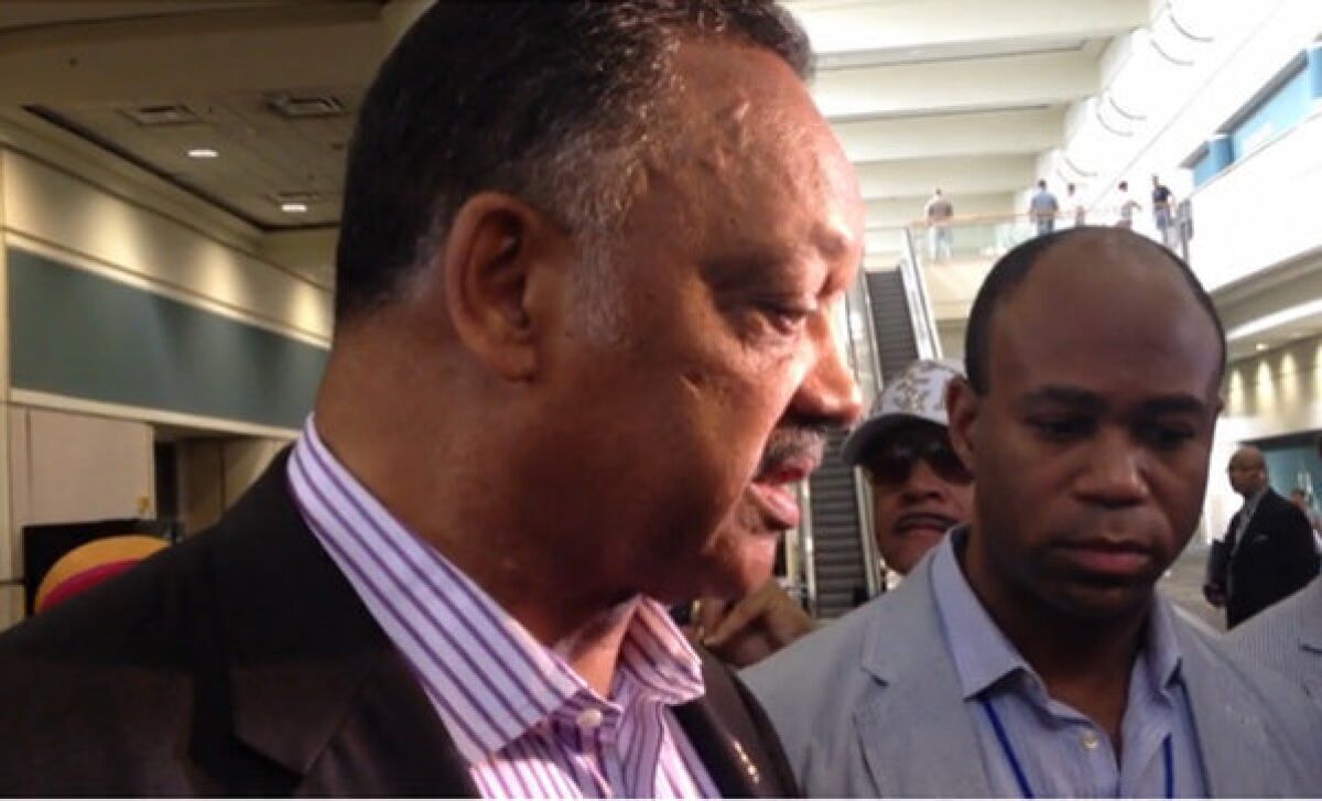 Civil rights leader the Rev. Jesse Jackson holds an impromptu news conference outside the NAACP convention in Orlando.