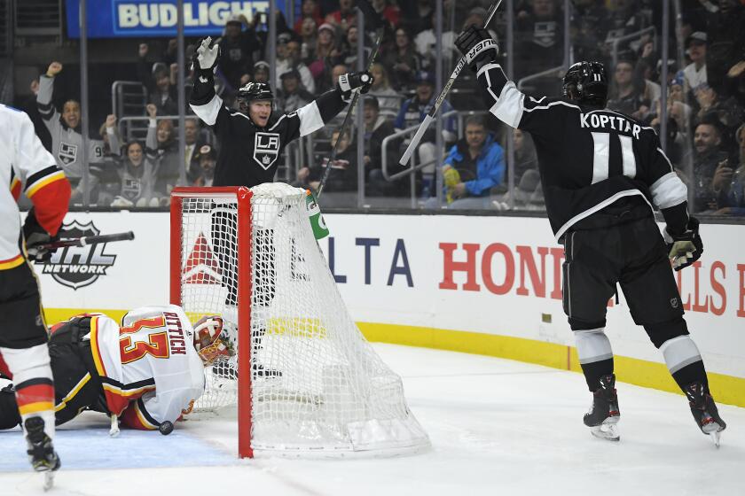 Los Angeles Kings right wing Tyler Toffoli, rear, celebrates with center Anze Kopitar, right, after Toffoli scored on Calgary Flames goaltender David Rittich during the second period of an NHL hockey game Wednesday, Feb. 12, 2020, in Los Angeles. (AP Photo/Mark J. Terrill)