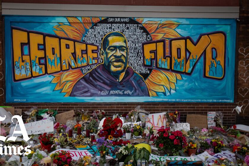 MINNEAPOLIS , MINNESOTA - MAY 31: The makeshift memorial and mural outside Cup Foods where George Floyd was murdered by a Minneapolis police officer on Sunday, May 31, 2020 in Minneapolis , Minnesota. (Jason Armond / Los Angeles Times)