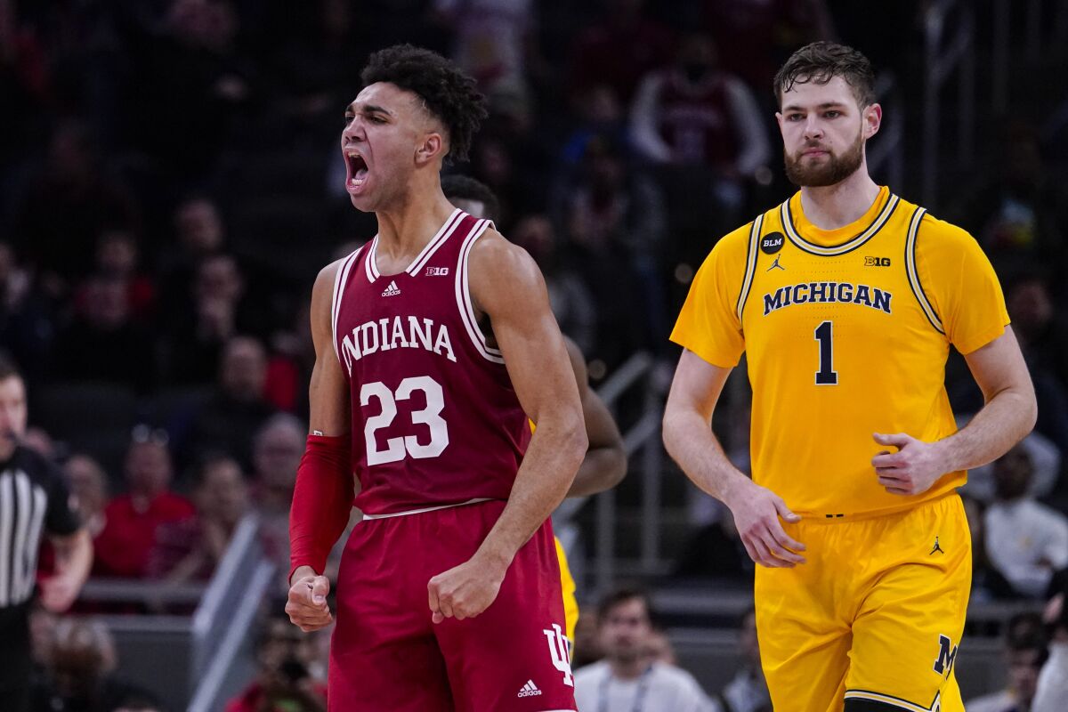 Indiana forward Trayce Jackson-Davis (23) celebrates a basket in front of Michigan center Hunter Dickinson (1) in the second half of an NCAA college basketball game at the Big Ten Conference tournament in Indianapolis, Thursday, March 10, 2022. Indiana defeated Michigan 74-69. (AP Photo/Michael Conroy)