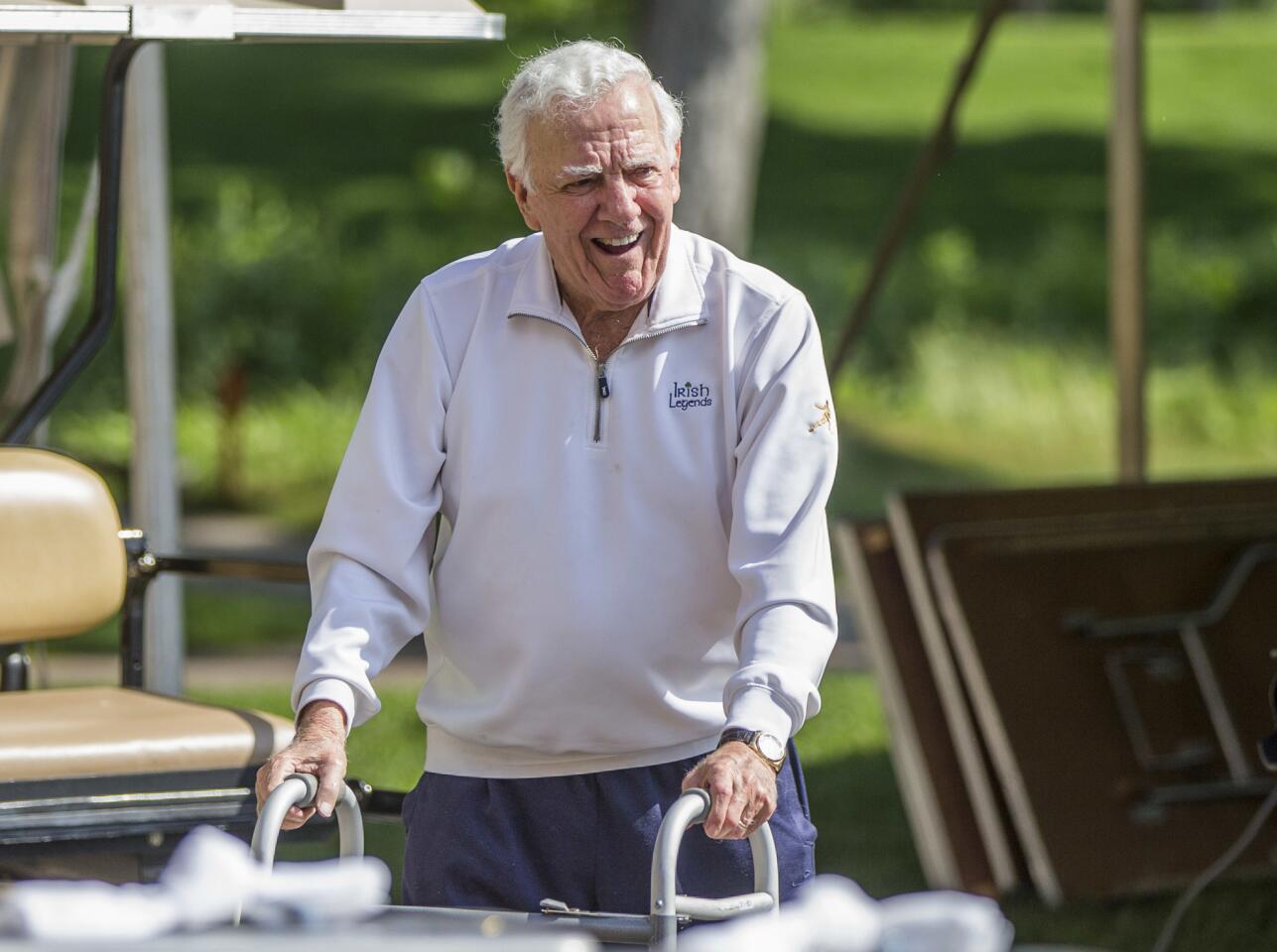 Former Notre Dame football coach Ara Parseghian makes his way to an interview area during the Kelly Cares Foundation Golf Invitational at Lost Dunes Golf Club in Bridgman, Mich., on June 13, 2016.
