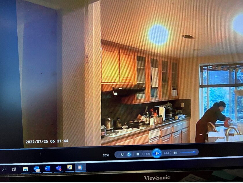 A woman pours from an orange container into a cup