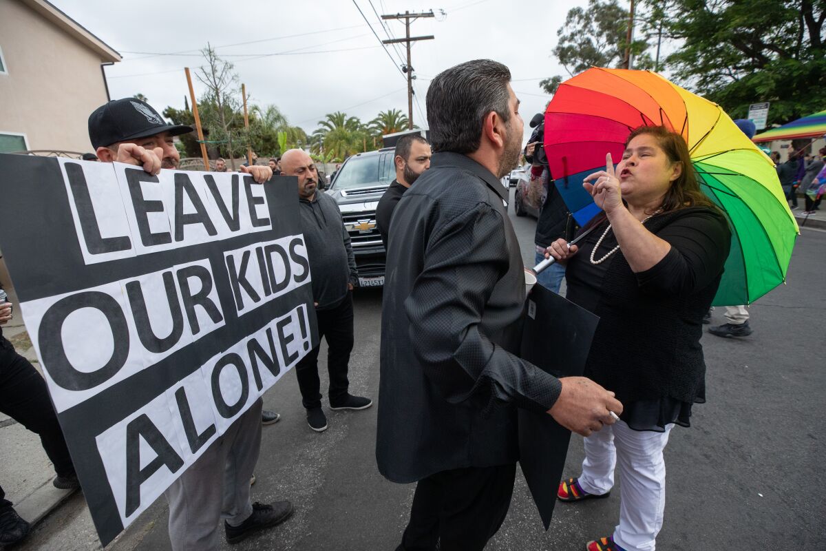 Protesters and counterprotesters face off in front of Saticoy Elementary School as parents