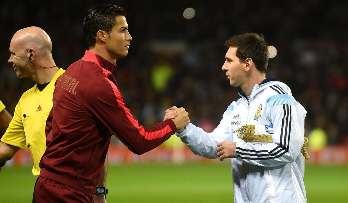 Lionel Messi, right, shakes hands with Cristiano Ronaldo ahead of kickoff of the international friendly soccer game between Argentina and Portugal on Nov. 18, 2014.