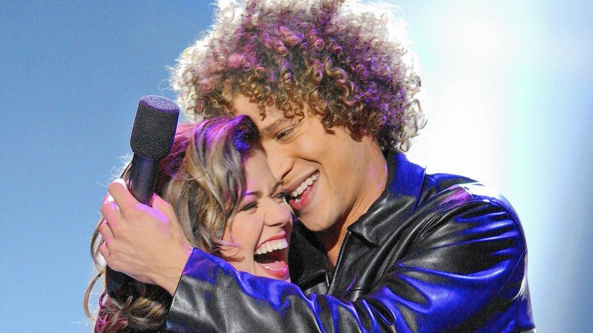 Kelly Clarkson embraces fellow "American Idol" competitor Justin Guarini after being crowned the first winner.