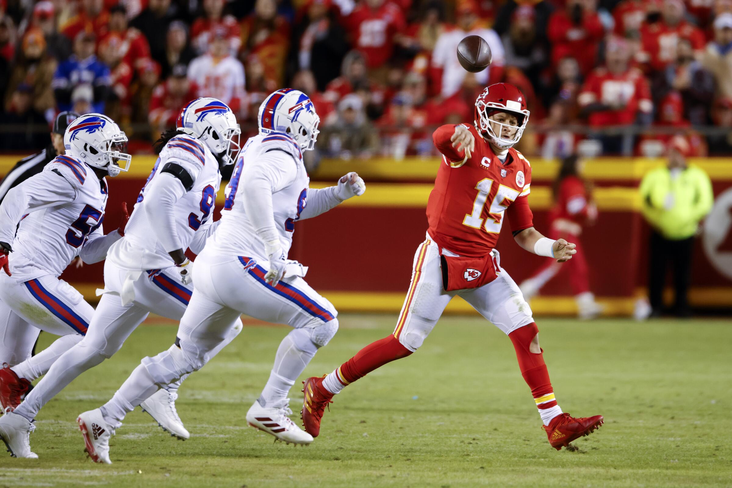 Chiefs quarterback Patrick Mahomes (15) throws a pass under pressure from the Bills defense in the playoffs last season.