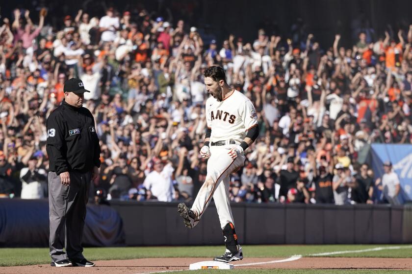 San Francisco Giants' Steven Duggar celebrates after hitting a two-run triple against the Los Angeles Dodgers during the second inning of a baseball game in San Francisco, Sunday, Sept. 5, 2021. (AP Photo/Jeff Chiu)