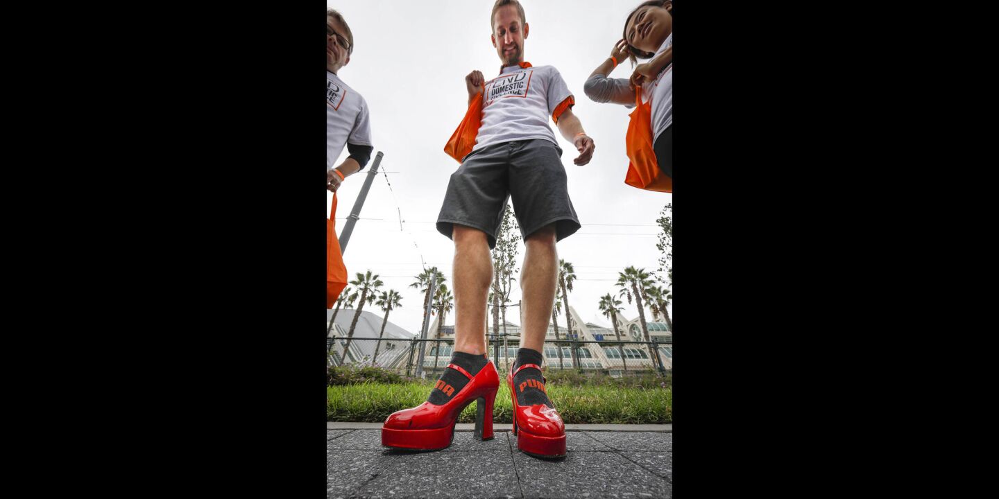 Karl Yoder of La Jolla, sporting red high heels, was one of a couple of hundred people to walk through the Gaslamp Quarter during the YWCA'S 11th annual "Walk a Mile in Her Shoes," taking a stand against domestic violence.