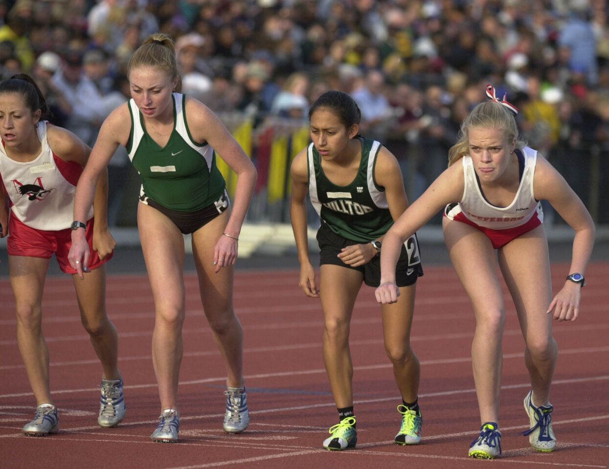 Hilltop's Desiree Davila (center) glances at her competion as Clara Horowitz (left) from Oakland, Ca., and Kelley Otstott from Thomas Jefferson High School prepare for the start of the Women's 1600 meter race at the Arcadia Invitational track meet April 14, 2001.