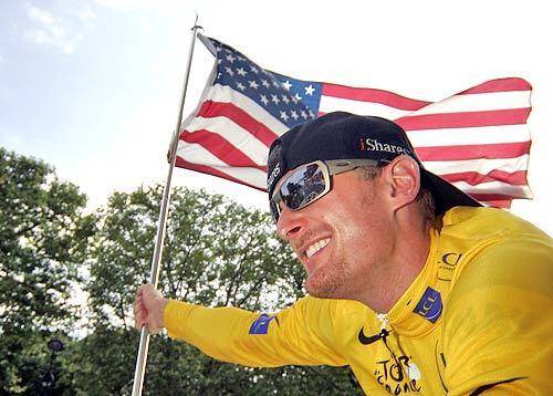 PATRIOT: Tour de France winner Floyd Landis waves the U.S. flag on the final leg of the endurance race, which ended July 23. The U.S. Anti-Doping Agency subsequently accused him of doping with testosterone. Landis is fighting the charge and denies taking any performance-enhancing drugs.