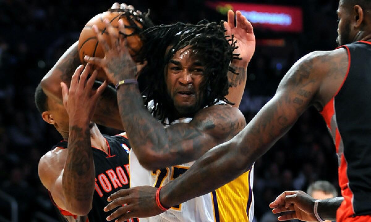 Lakers center Jordan Hill grabs an offensive rebound during a Dec. 8 loss to the Toronto Raptors at Staples Center.